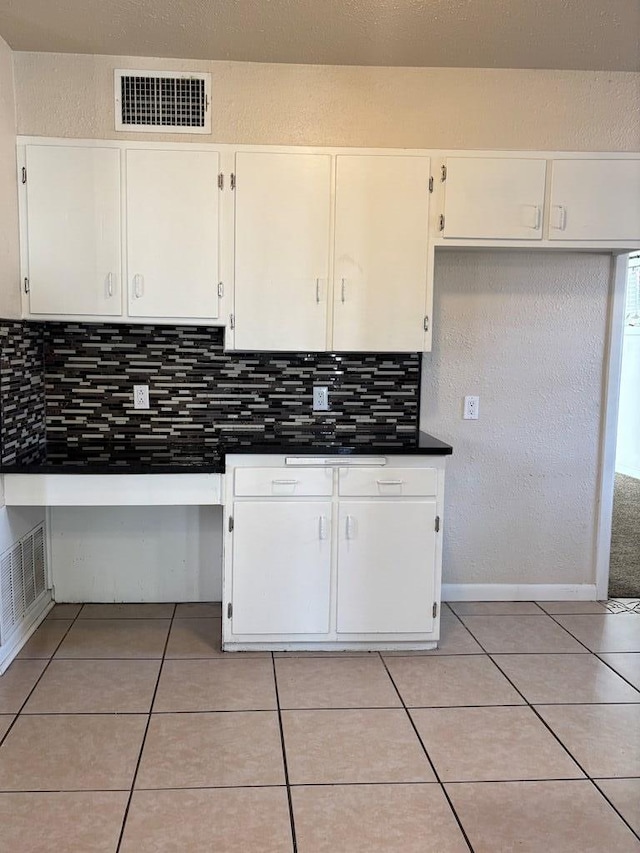 kitchen with white cabinets and light tile patterned floors