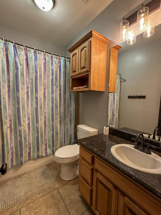 full bathroom featuring tile patterned flooring, vanity, shower / bath combo, and toilet