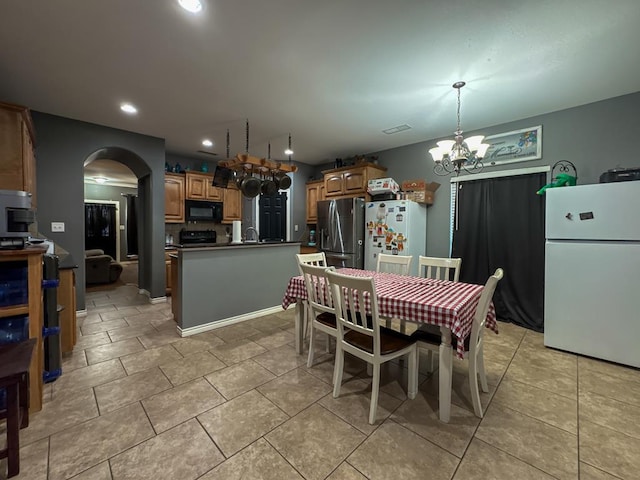 dining room featuring a notable chandelier and light tile patterned flooring