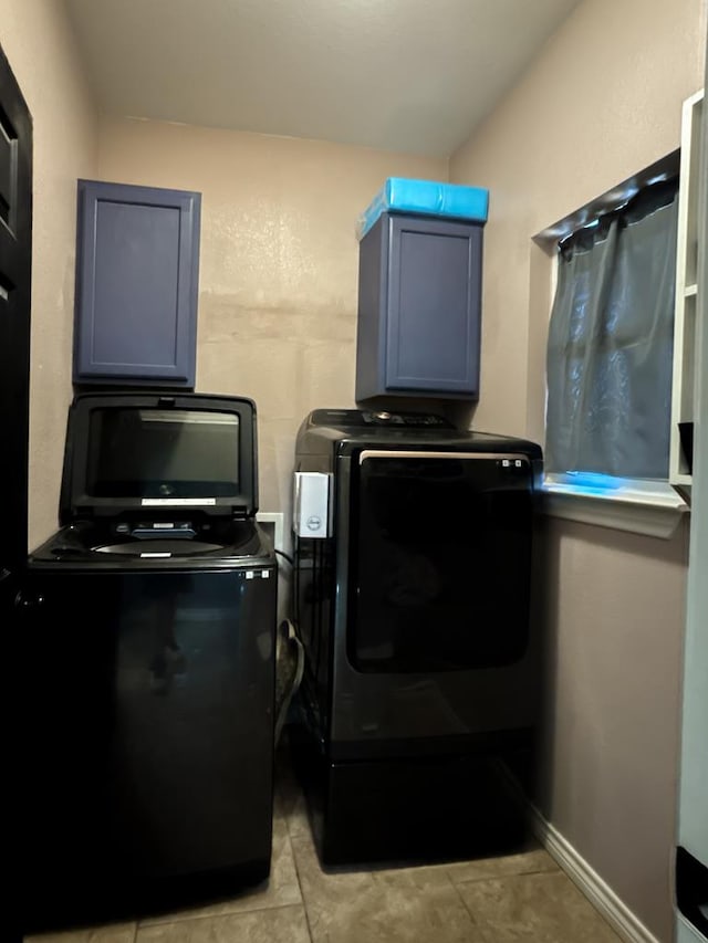 washroom with washer and dryer and light tile patterned floors