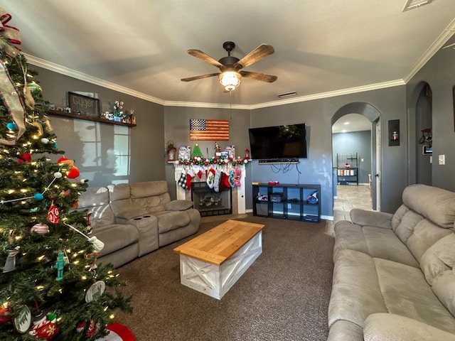 carpeted living room with ceiling fan and ornamental molding