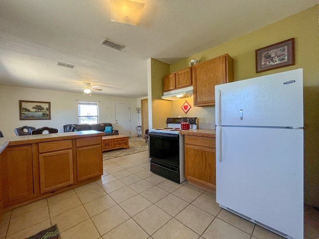 kitchen with ceiling fan, white fridge, light tile patterned floors, and black / electric stove