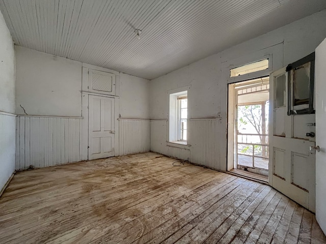 interior space featuring wooden walls and light hardwood / wood-style floors