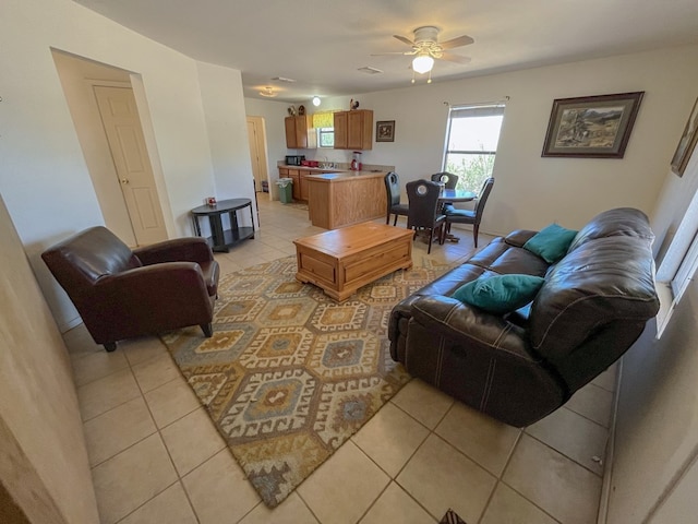 living room featuring ceiling fan and light tile patterned flooring