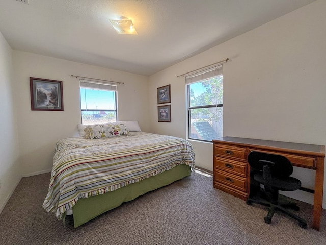 bedroom featuring carpet flooring and multiple windows