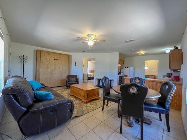 tiled dining area with ceiling fan