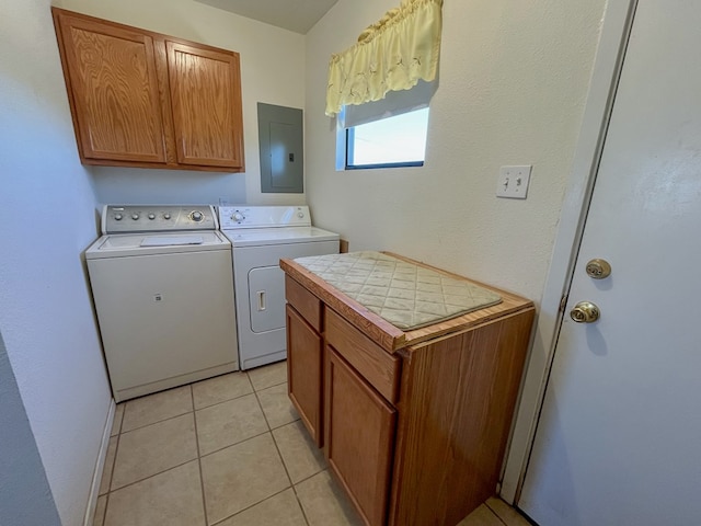 clothes washing area with cabinets, washing machine and dryer, light tile patterned floors, and electric panel