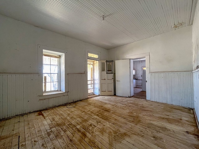 interior space with wood walls and light wood-type flooring