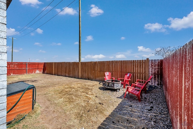 view of yard with a fire pit and a fenced backyard