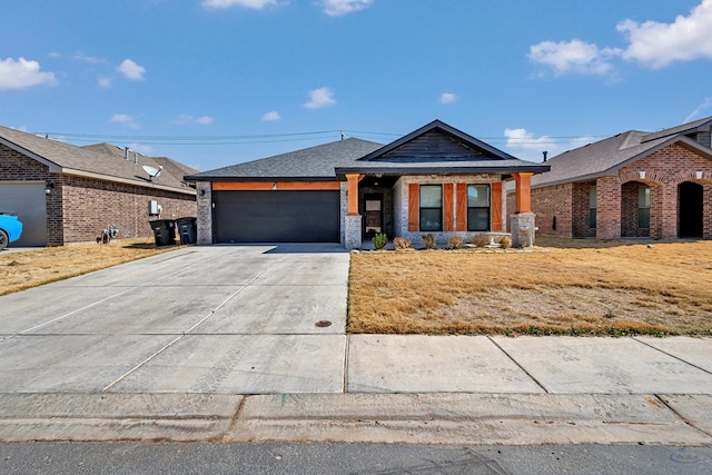 view of front of home with concrete driveway, an attached garage, and brick siding