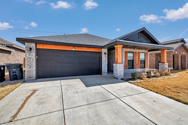 view of front of property featuring an attached garage, brick siding, driveway, and roof with shingles