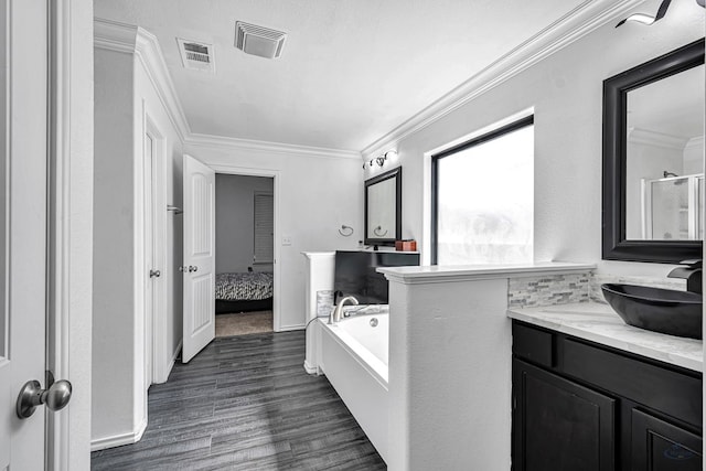 bathroom with ensuite bath, visible vents, wood finished floors, and ornamental molding