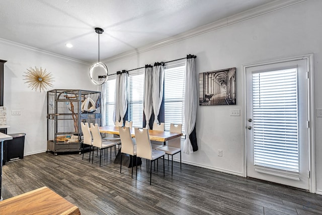 dining room with a textured ceiling, dark wood-style floors, baseboards, and ornamental molding