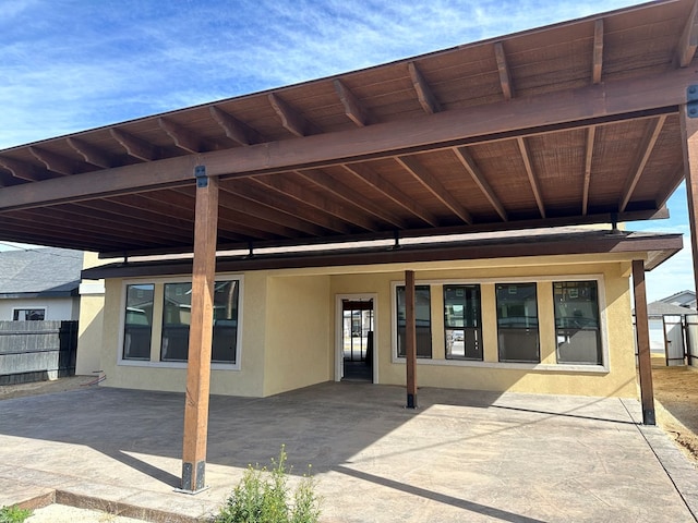 exterior space with fence and stucco siding