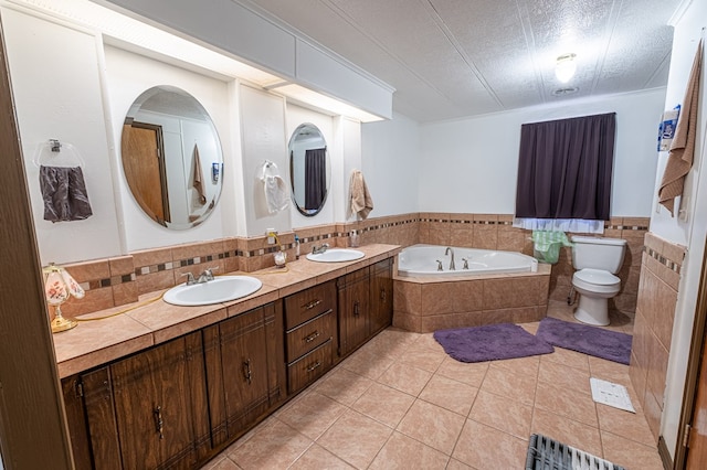 bathroom featuring tile patterned flooring, tile walls, vanity, a relaxing tiled tub, and toilet