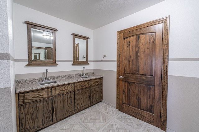 bathroom with vanity and a textured ceiling