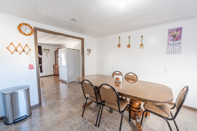 dining area featuring a textured ceiling