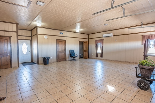 foyer featuring light tile patterned floors and a wall unit AC