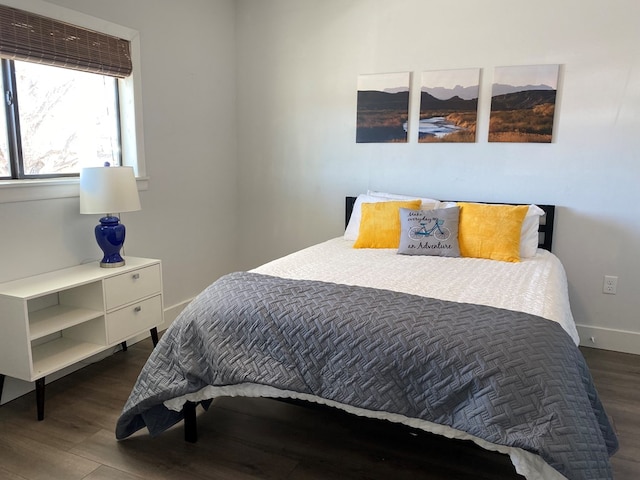 bedroom with dark wood-type flooring