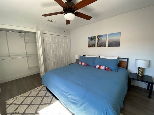 bedroom with ceiling fan and dark wood-type flooring