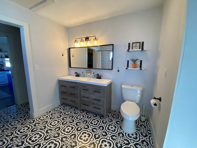 bathroom featuring tile patterned floors, vanity, and toilet