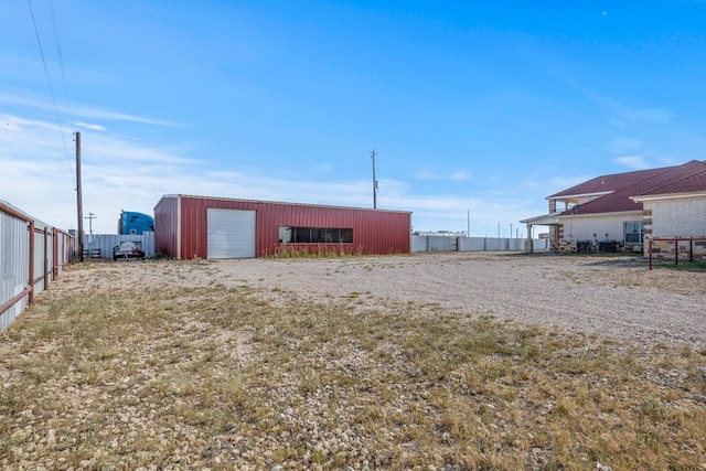 view of yard with a garage and an outdoor structure