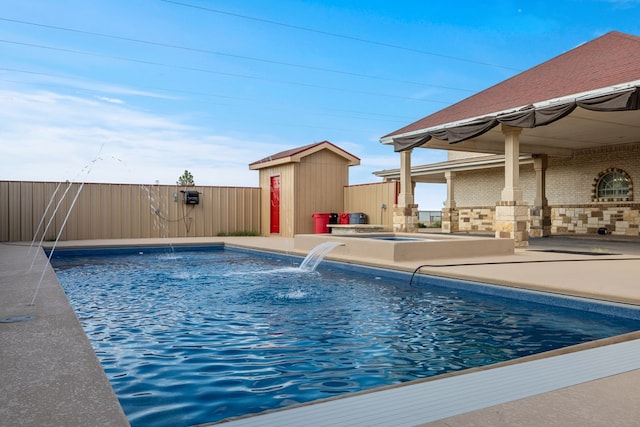 view of swimming pool with a patio area, pool water feature, and a storage shed