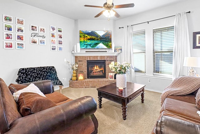 carpeted living room featuring a brick fireplace and ceiling fan