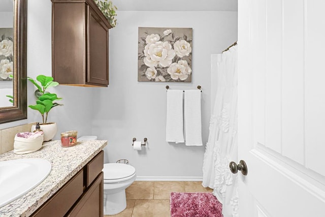 bathroom with tile patterned flooring, vanity, and toilet