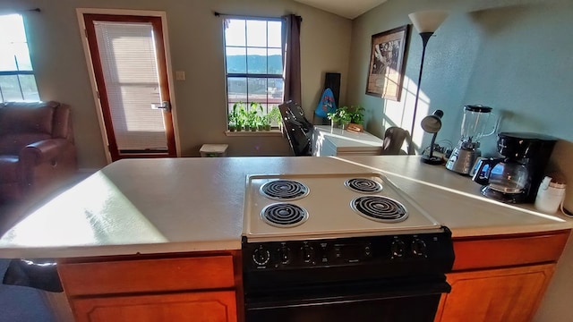 kitchen featuring a mountain view and black stove