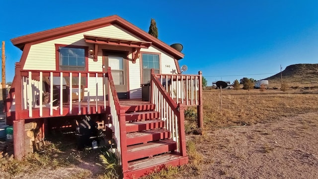 back of property featuring a wooden deck