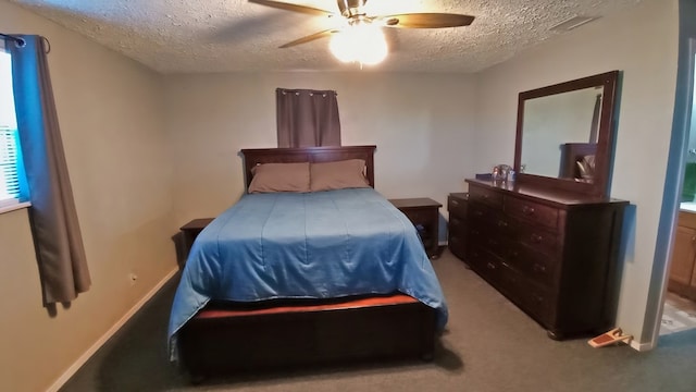 bedroom featuring ceiling fan, carpet floors, and a textured ceiling