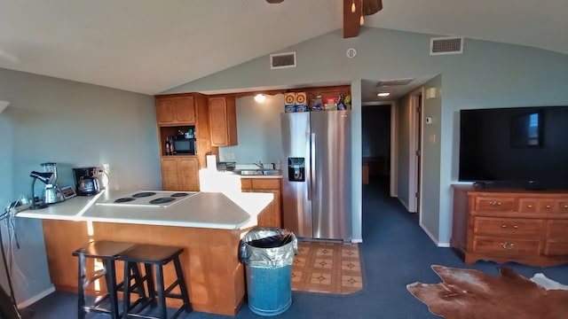 kitchen featuring kitchen peninsula, a breakfast bar, lofted ceiling with beams, stainless steel fridge with ice dispenser, and white electric cooktop