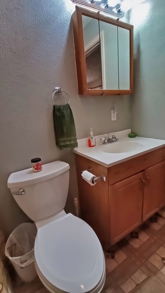 bathroom with tile patterned floors, vanity, and toilet