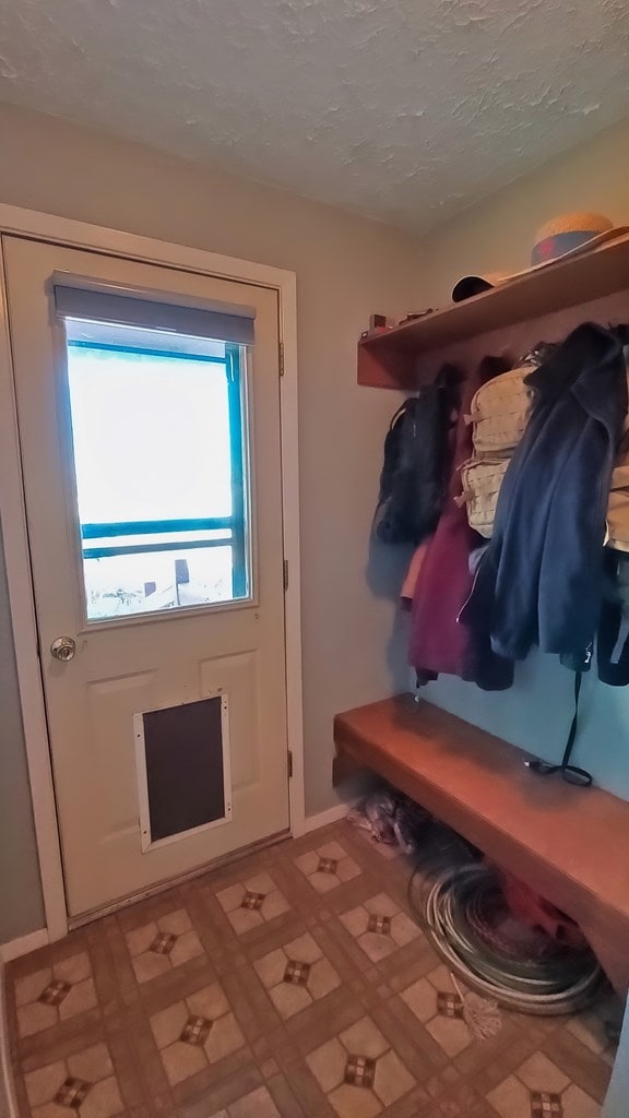 mudroom with a textured ceiling