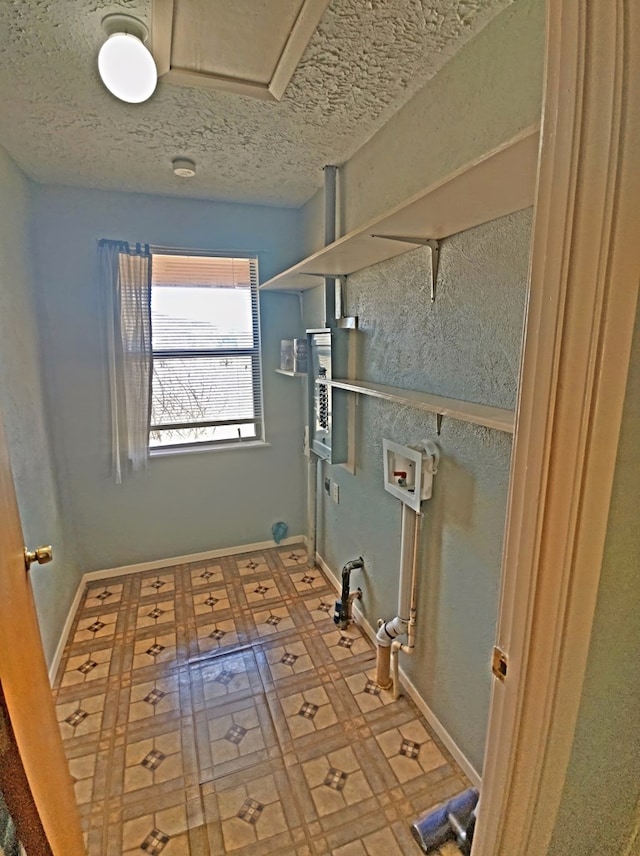 clothes washing area featuring washer hookup and a textured ceiling