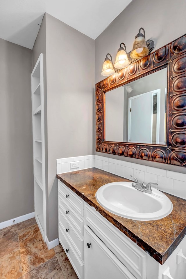 bathroom with tasteful backsplash and vanity