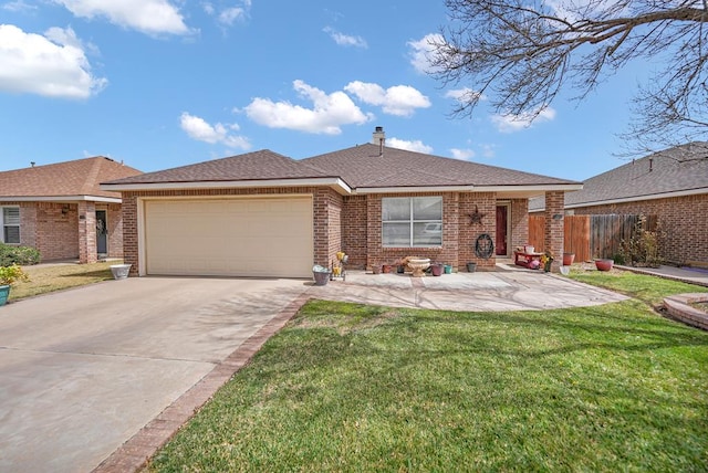 view of front of home with driveway, a front yard, a shingled roof, a garage, and brick siding