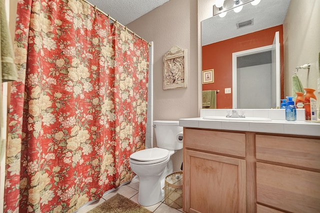 bathroom with visible vents, toilet, vanity, tile patterned floors, and a textured ceiling