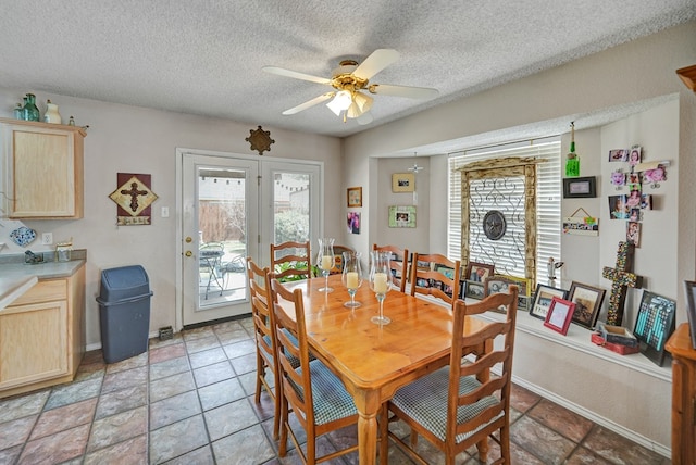 dining room with a textured ceiling and ceiling fan