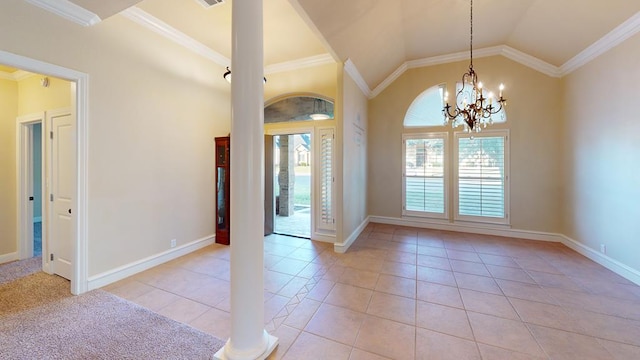 tiled entryway featuring crown molding, lofted ceiling, and an inviting chandelier