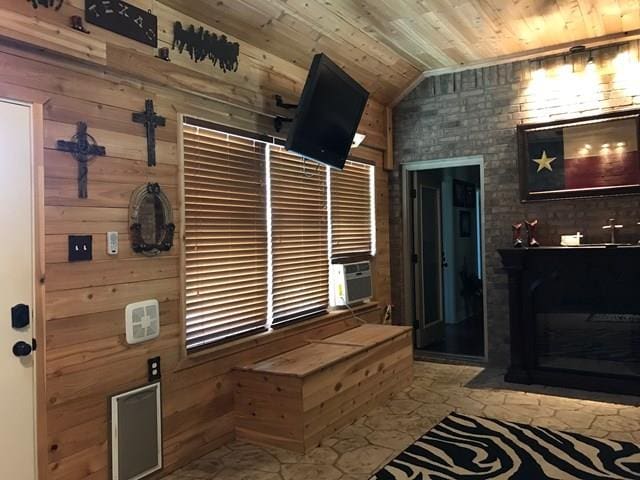 mudroom featuring wood ceiling, lofted ceiling, wooden walls, and cooling unit