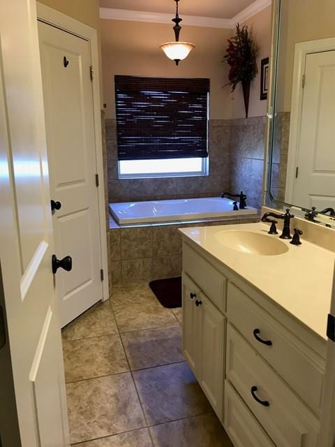 bathroom with a relaxing tiled tub, vanity, and tile patterned floors