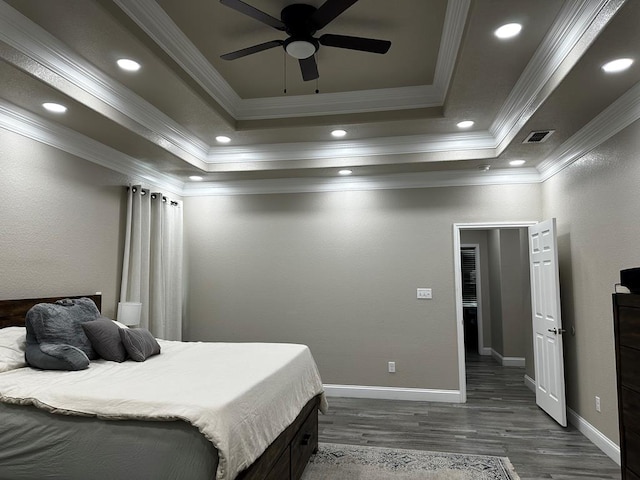 bedroom with a raised ceiling, ceiling fan, dark hardwood / wood-style flooring, and ornamental molding