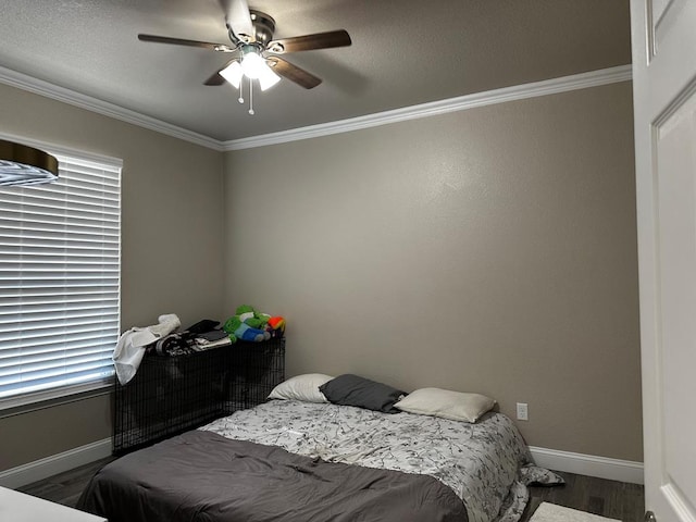 bedroom featuring wood-type flooring, ceiling fan, and crown molding