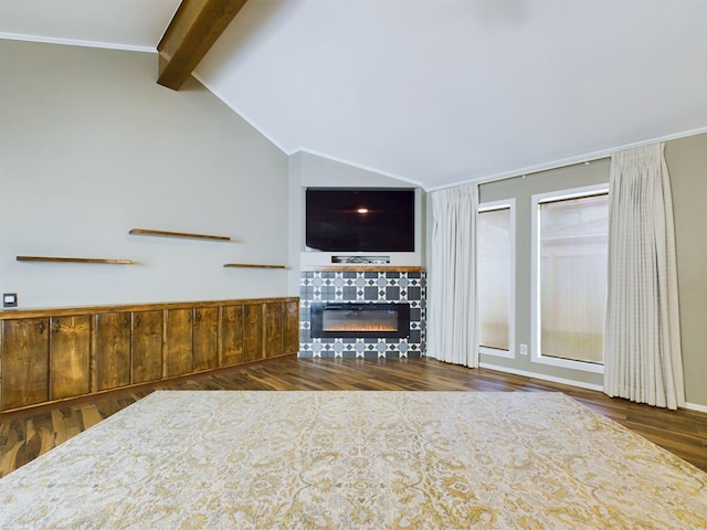 unfurnished living room with a tile fireplace, vaulted ceiling with beams, dark hardwood / wood-style floors, and crown molding