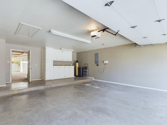 garage featuring electric panel and a garage door opener