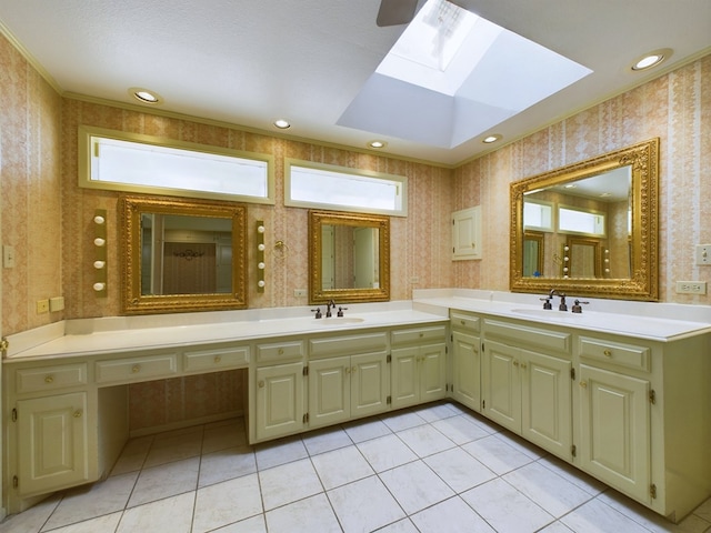 bathroom with tile patterned floors, vanity, ornamental molding, and a skylight