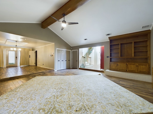 unfurnished living room featuring vaulted ceiling with beams, dark wood-type flooring, and ceiling fan with notable chandelier