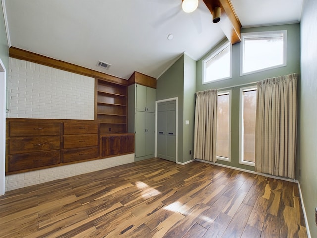 unfurnished bedroom with vaulted ceiling with beams, ceiling fan, and dark hardwood / wood-style floors